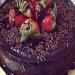 fresh strawberry toppings on a chocolate cake