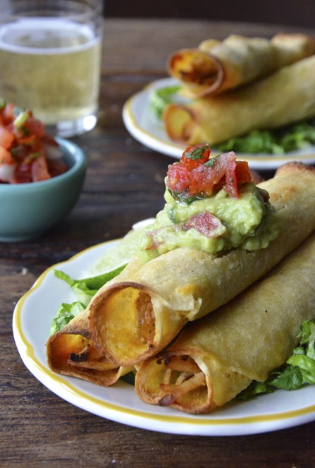 Who's ready for a lighter take on Mexican food? Ditch the deep-fryer for Crispy Baked Chicken and Cheese Taquitos topped with fresh salsa and guac. #recipe   #healthy   #healthyeating   #chicken