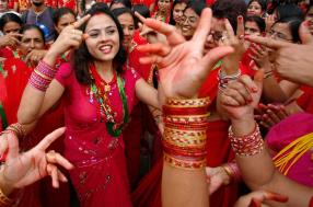 Hindu women take part in a traditional dance at Pashupati Nath Temple during celebrations of the Teej festival in Kathmandu. Married women wear red bridal dresses to celebrate the Teej festival